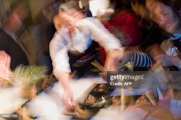 Chef rushes to prepare a dish at the "Seven Sushi Samurai" Sushi of the Year awards 2009 at the Olympia exhibition centre in west London, on November...