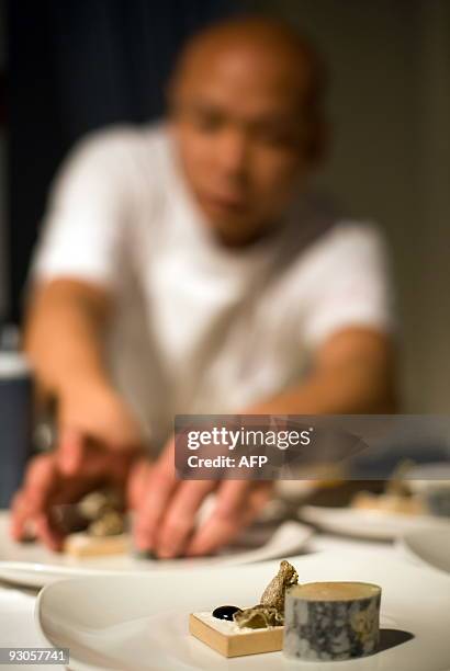 Sayan Isaksson of Sweden adds the finishing touches to his dish at the "Seven Sushi Samurai" Sushi of the Year awards 2009 at the Olympia exhibition...