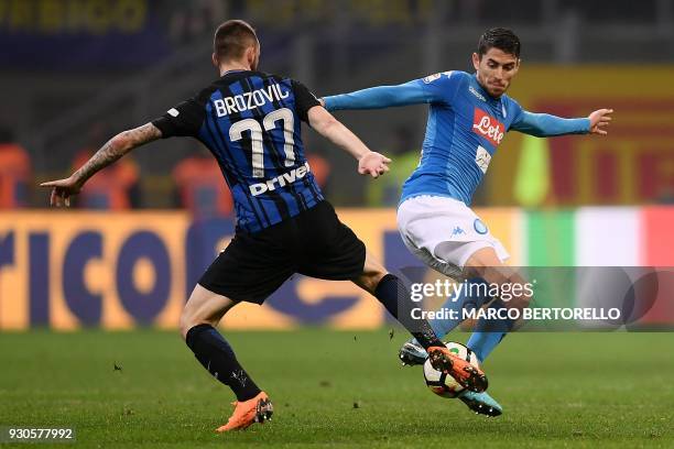 Inter Milan's Croatian midfielder Marcelo Brozovic tackles Napoli's Brazilian midfielder Jorginho during the Italian Serie A football match Inter...