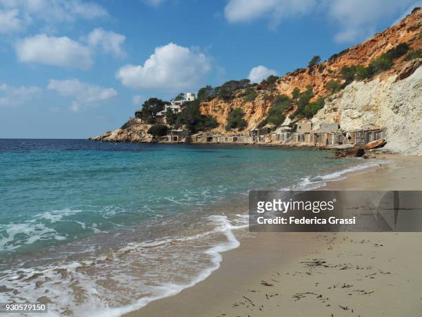 the beach at cala d'hort and es vedrà island, ibiza island - beach at cala d'or stock pictures, royalty-free photos & images