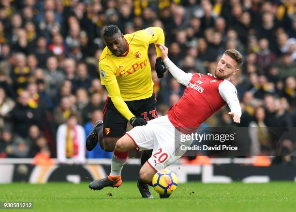 Shkodran Mustafi of Arsenal is challenged by Stefano Okaka of Watford during the Premier League match between Arsenal and Watford at Emirates Stadium...