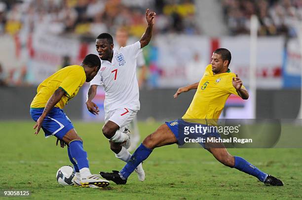 Shaun Wright-Phillips of England takes on Felipe Melo De Carvalho and Michel Fernandes Bastos of Brazil during the International Friendly match...