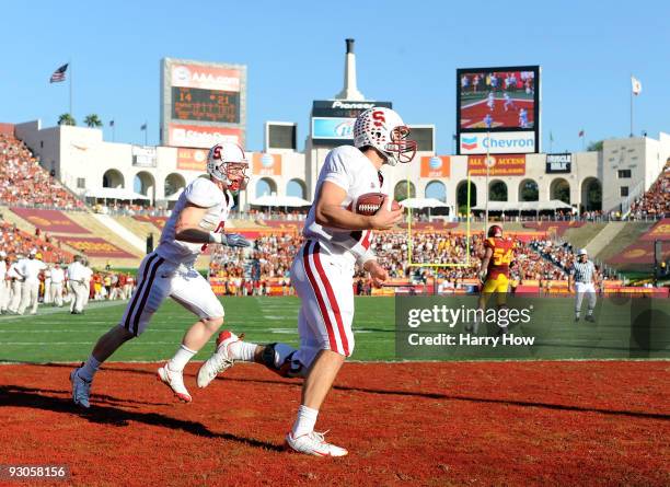 Andrew Luck of the Stanford Cardinal celebrates his touchdown with Ryan Whalen for against the USC Trojans during the second half at the Los Angeles...