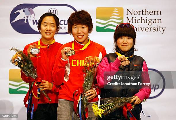 Women's 1500m gold medalist Yang Zhou of China ; silver medalist Qiuhong Liu of China , and bronze medalist Eun-Byul Lee of Korea pose on the medal...