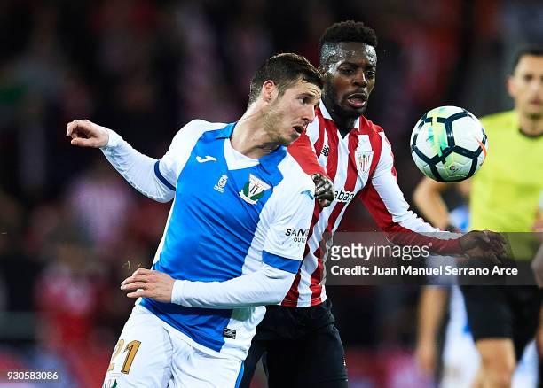 Inaki Williams of Athletic Club competes for the ball with Ruben Perez of Club Deportivo Leganes during the La Liga match between Athletic Club...