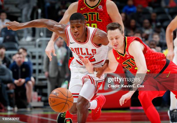 Kris Dunn of the Chicago Bulls attempts to steal the ball from Josh Magette of the Atlanta Hawks at Philips Arena on March 11, 2018 in Atlanta,...