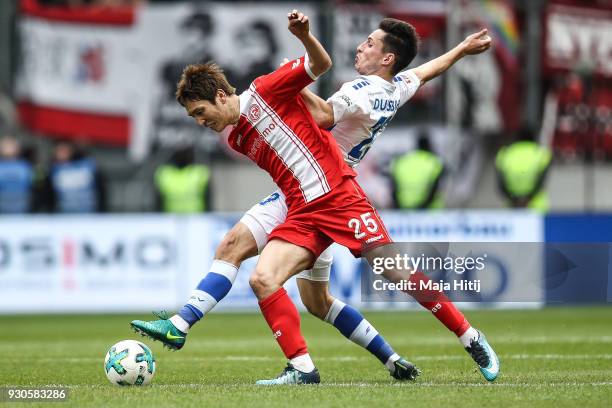 Fabian Schnellhardt of MSV Duisburg and Genki Haraguchi of Fortuna Duesseldorf battle for the ball during the Second Bundesliga match between MSV...