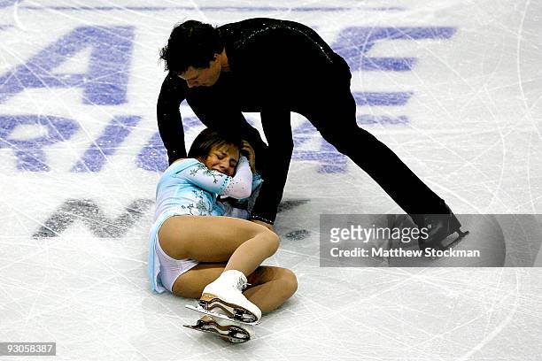 Meagan Duhamel of Canada is attended to by her partner Craig Buntin of Canada after she crashed to the ice while competing in the Free Skate during...