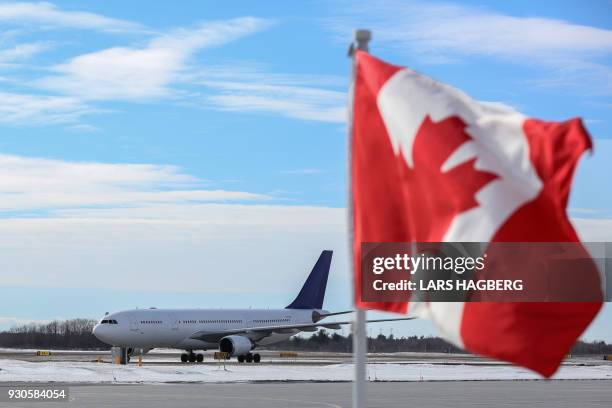 The airplane carrying King Philippe and Queen Mathilde of Belgium arrives at Ottawa International Airport in Ottawa, Ontario, on March 11, 2018. /...