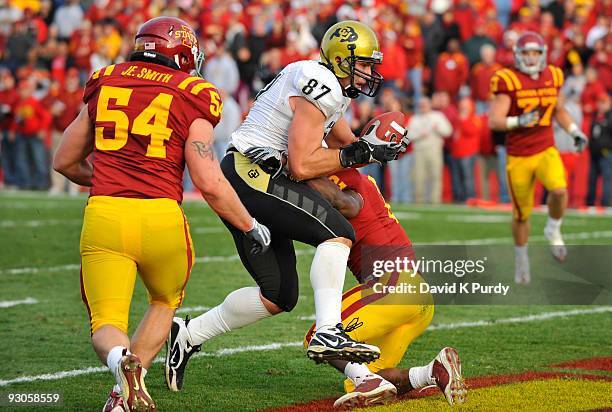 Defensive back James Smith of the Iowa State Cyclones breaks up a pass intended for Tight end Riar Geer of the Colorado Buffaloes while linebacker...