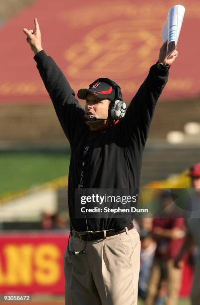 Head coach Jim Harbaugh of the Stanford Cardinal signals during the game with the USC Trojans on November 14, 2009 at the Los Angeles Coliseum in Los...