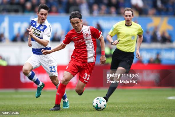 Fabian Schnellhardt of MSV Duisburg and Takashi Usami of Fortuna Duesseldorf battle for the ball during the Second Bundesliga match between MSV...