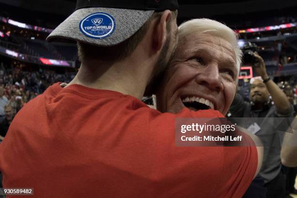 Head coach Bob McKillop of the Davidson Wildcats hugs Jon Axel Gudmundsson after defeating the Rhode Island Rams in the Championship game of the...