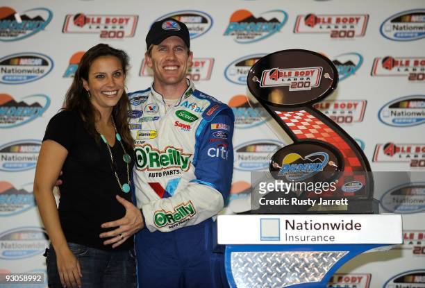 Kate Edwards and Carl Edwards , driver of the Valvoline/O'Reilly Auto Parts Ford, celebrate in victory lane after winning the NASCAR Nationwide...