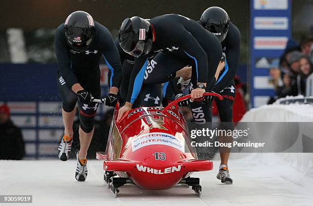 Driver Todd Hays of the USA boards his sled as his team pushes from the start for the first run of the FIBT World Cup Four Man Bobsleigh at the Utah...