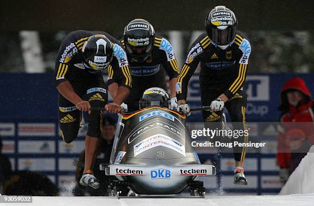 Driver Andre Lange of Germany boards his sled out of the start house as his team pushes for the first run of the FIBT World Cup Four Man Bobsleigh at...