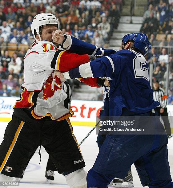 Brian McGratton of the Calgary Flames takes a big punch off the nose from Colton Orr of the Toronto Maple Leafs on November 14, 2009 at the Air...
