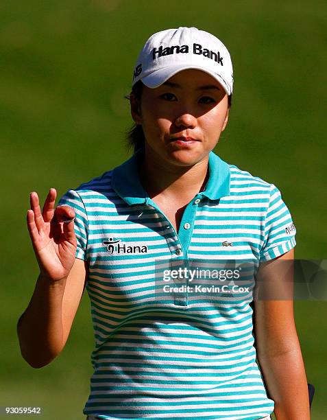 In-Kyung Kim of South Korea acknowledges the gallery after her second shot on the 16th hole during the third round of the Lorena Ochoa Invitational...