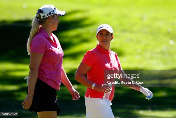 Cristie Kerr and Brittany Lincicome , both of the United States, converse as they walk down the fourth fairway during the third round of the Lorena...