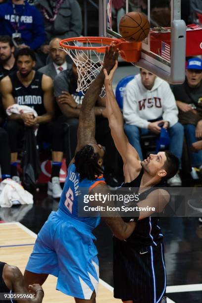 Orlando Magic center Nikola Vucevic gets a hand on LA Clippers center DeAndre Jordan as he goes up for a rebound during the game between the Orlando...