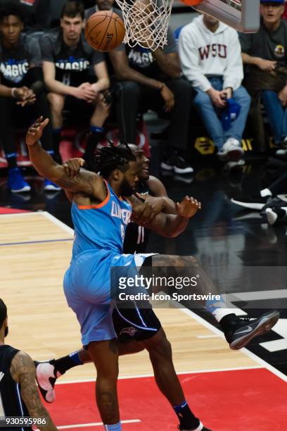 Orlando Magic center Bismack Biyombo grabs on to LA Clippers center DeAndre Jordan and drags him down as he goes to the basket during the game...