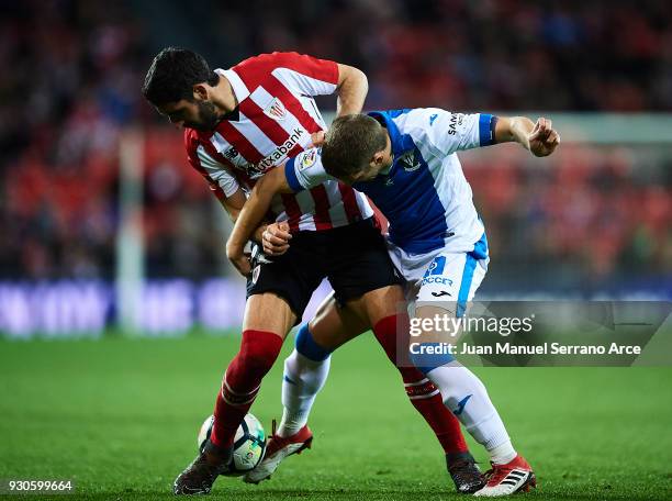 Raul Garcia of Athletic Club competes for the ball with Darko Brasanac of Club Deportivo Leganes during the La Liga match between Athletic Club...