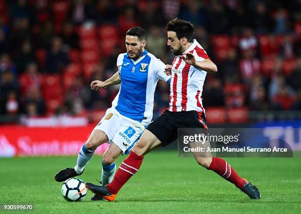 Benat Etxebarria of Athletic Club competes for the ball with Joseba Zaldua of Club Deportivo Leganes during the La Liga match between Athletic Club...