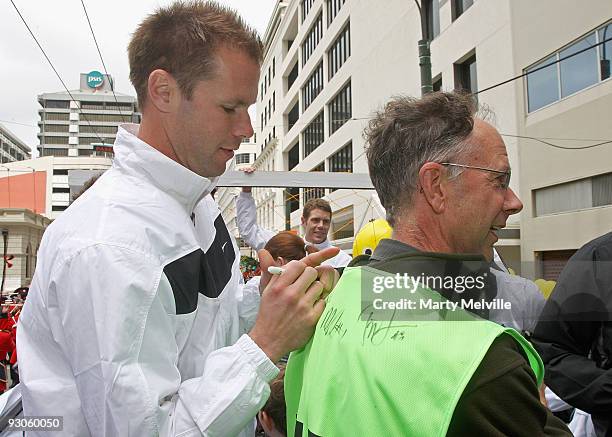 Mark Paston keeper for the All Whites signs a photographers vest during a victory parade through the CBD on November 15, 2009 in Wellington, New...