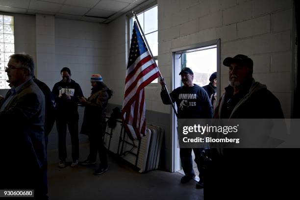 Member of the United Mine Workers of America holds an American flag before a campaign rally with Conor Lamb, Democratic candidate for the U.S. House...