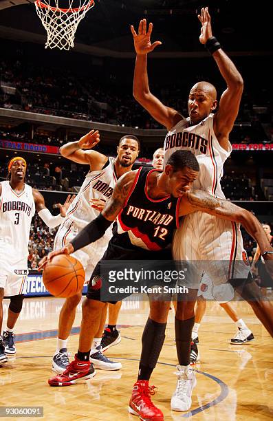 LaMarcus Aldridge of the Portland Trail Blazers drives around the pick against Raja Bell of the Charlotte Bobcats on November 14, 2009 at the Time...