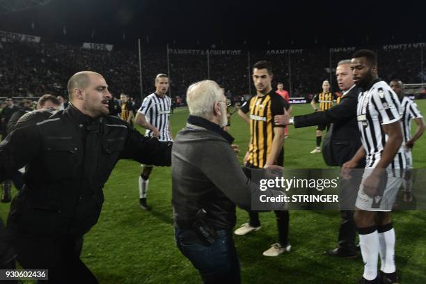 S Greek-Russian president Ivan Savvidis takes to the pitch carrying a handgun in his waistband , after the referee refused a last minute goal on...