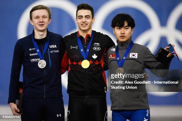 Ethan Cepuran of the United States, David la Rue of Canada and Min Seok Kim of Korea stand on the podium after winning the men's mass start during...