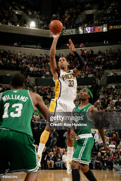 Danny Granger of the Indiana Pacers shoots over Shelden Williams and Marquis Daniels of the Boston Celtics at Conseco Fieldhouse on November 14, 2009...