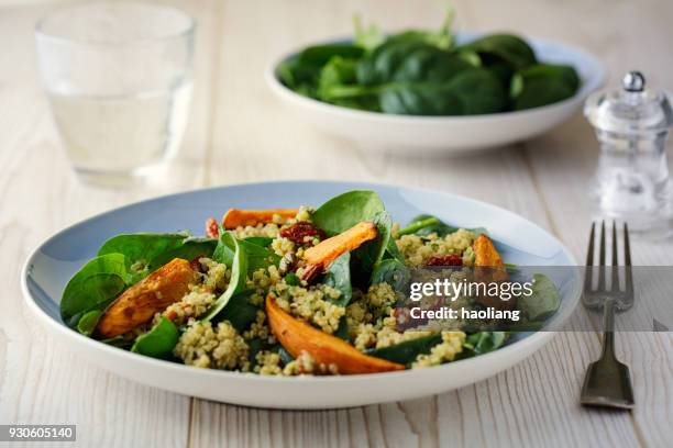 healthy quinoa salad with roasted sweet potatoes wedges - quinoa salad stock pictures, royalty-free photos & images