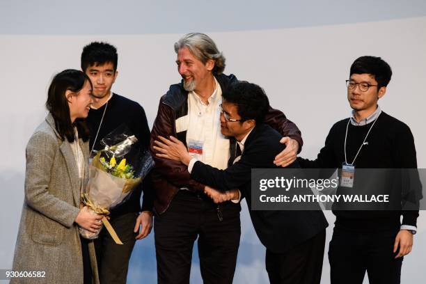 Pro-democracy candidate Au Nok-hin is congratulated by disqualified lawmaker Nathan Law , disqualified candidate Agnes Chow and defeated...