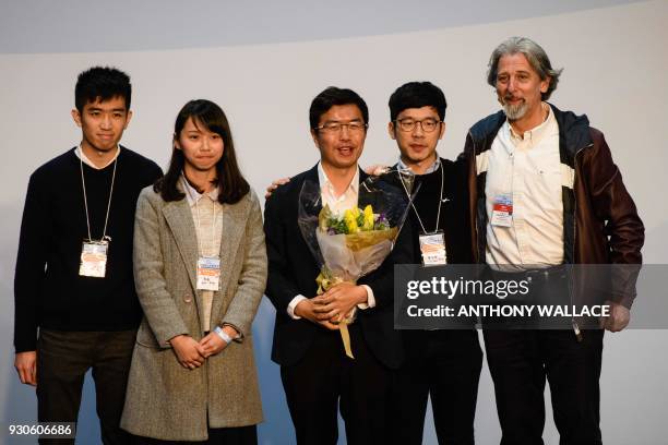 Pro-democracy candidate Au Nok-hin , flanked by disqualified lawmaker Nathan Law , disqualified candidate Agnes Chow and defeated pro-democracy...