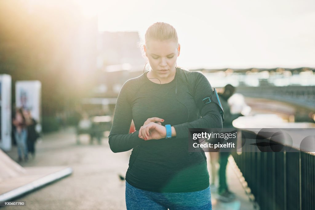 Sportswoman looking at her smart watch