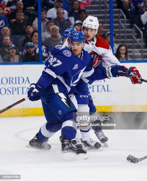 Ryan McDonagh of the Tampa Bay Lightning skates against Jacob de la Rose of the Montreal Canadiens during the second period at Amalie Arena on March...