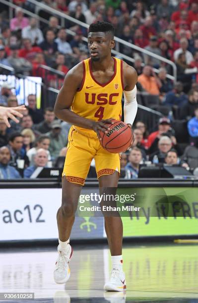 Chimezie Metu of the USC Trojans looks to pass against the Arizona Wildcats during the championship game of the Pac-12 basketball tournament at...