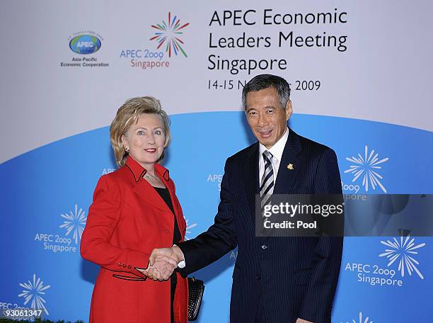 Singapore's Prime Minister Lee Hsien Loong welcomes U.S. Secretary of State Hillary Clinton for the APEC Leaders Summit at the Istana. President...