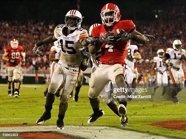 Tailback Caleb King of the Georgia Bulldogs runs in for the winning touchdown past defensive back Neiko Thorpe of the Auburn Tigers during the game...