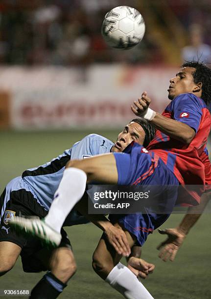 Uruguay's Alvaro Gonzalez vies for the ball with Costa Rica´s Esteban Sirias during their FIFA World Cup South Africa 2010 qualifier football match...