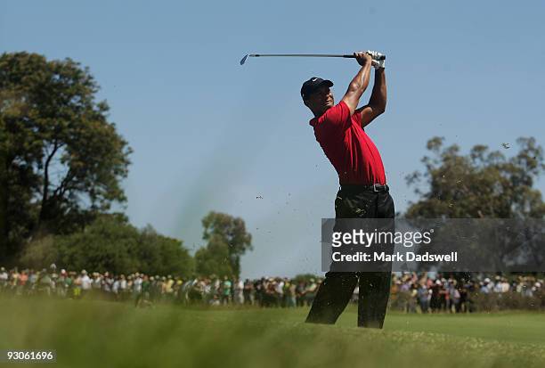 Tiger Woods of the USA plays an approach shot on the 7th hole during the final round of the 2009 Australian Masters at Kingston Heath Golf Club on...