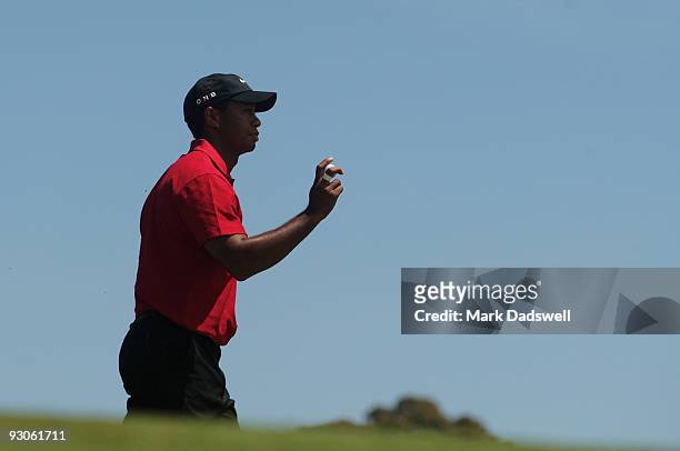 Tiger Woods of the USA acknowledges the crowd on the 4th hole during the final round of the 2009 Australian Masters at Kingston Heath Golf Club on...