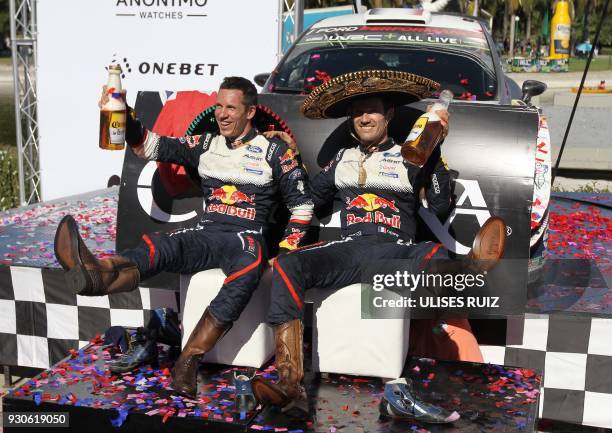 French Julien Ingrassia and Sebastian Ogier wearing the traditional boots and charro hat celebrate after winning the 2018 FIA World Rally Champions...