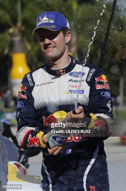 French Sebastian Ogier celebrates with champagne after winning the 2018 FIA World Rally Champions in Leon, Guanajuato state, Mexico, on March 11,...