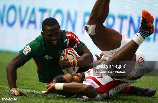 Samuel Oliech of Kenya is tackled by Matai Leuta of the United States away during the Canada Sevens, the Sixth round of the HSBC Sevens World Series...