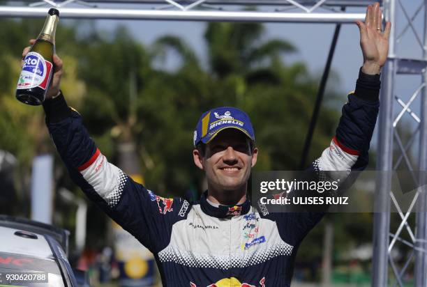 French Sebastian Ogier celebrates his victory after winning the 2018 FIA World Rally Champions in Leon, Guanajuato State, Mexico, on March 11, 2018....