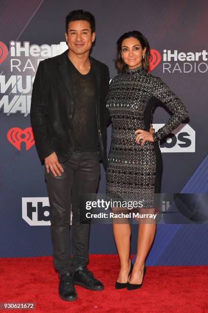 Mario Lopez and Courtney Laine Mazza arrive at the 2018 iHeartRadio Music Awards which broadcasted live on TBS, TNT, and truTV at The Forum on March...