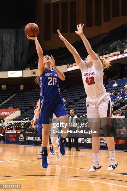 Jordyn Frantz of the Saint Louis Billikens drives to the basket Kadri-Ann Lass of the Duquesne Lady Dukes during the quarterfinal round of the...